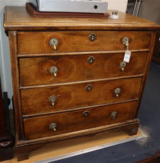 An early 18th century banded and inlaid walnut chest, fitted four long drawers W.90cm